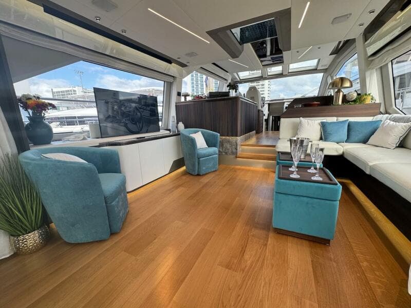 Luxurious interior of 2024 Aicon 66 Vivere yacht with modern furnishings and panoramic windows.