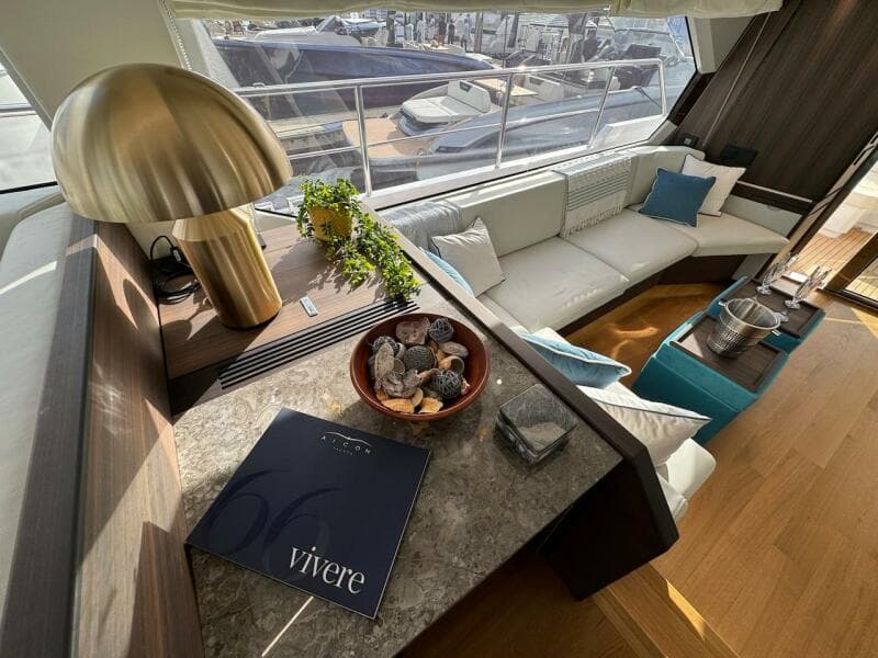 Luxurious interior of 2024 Aicon 66 Vivere yacht with elegant decor and seating.