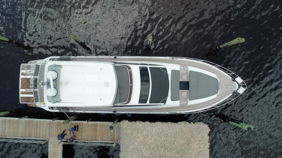 Aerial view of 2024 Aicon 66 Vivere luxury yacht docked at a marina.