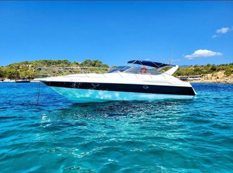 2003 Cranchi Endurance 39 yacht on clear blue water, sunny day, scenic background.