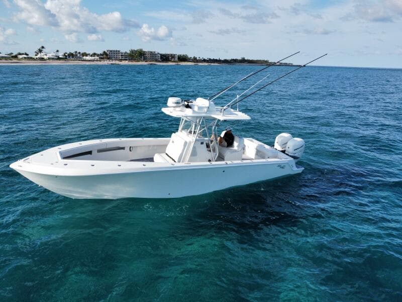 2017 SeaVee 340Z boat on clear blue ocean water, with fishing rods and distant shoreline.