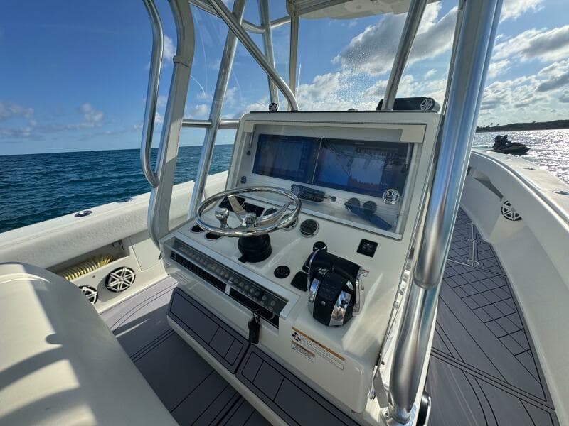 2017 SeaVee 340Z boat console with steering wheel and navigation screens on open water.