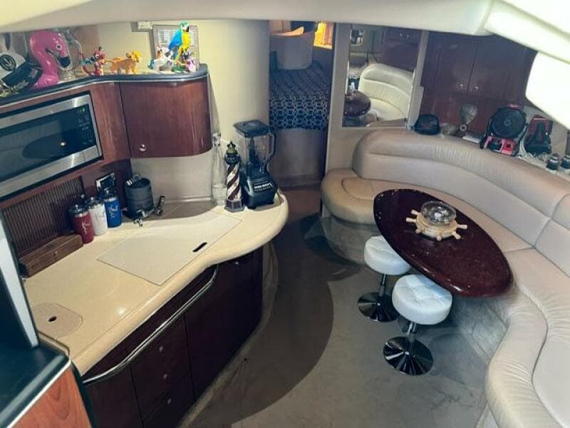 Interior of 2003 Sea Ray 380 Sundancer yacht with kitchen and seating area.