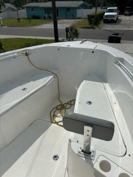2016 Release 208 RX boat interior with seating and rope, parked in a residential area.
