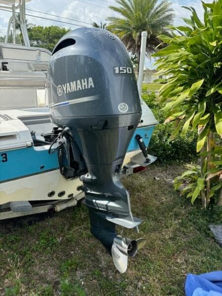 2016 Release 208 RX boat with Yamaha 150 outboard motor, parked outdoors.