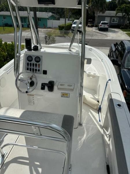 2016 Release 208 RX boat with console and seating, parked in a residential area.