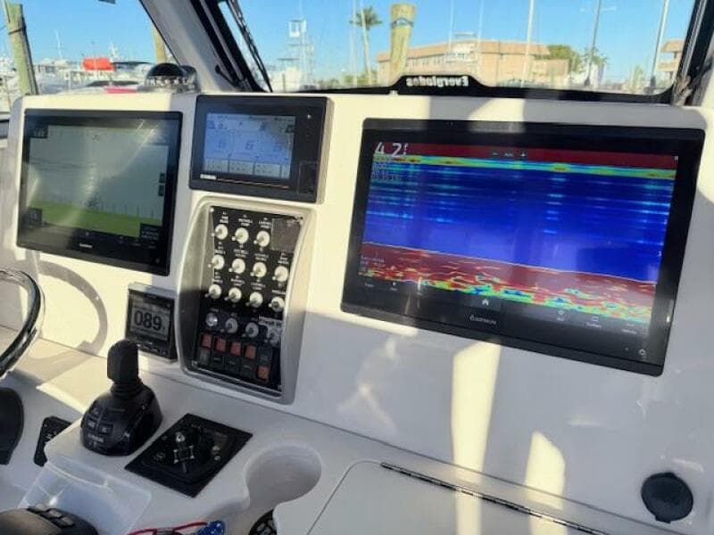 Control panel of 2014 Everglades 355 Center Console with navigation screens and controls.