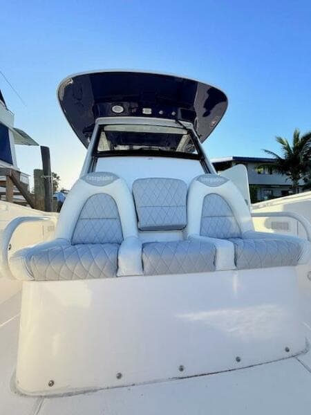 2014 Everglades 355 Center Console boat with cushioned seating and sleek design.