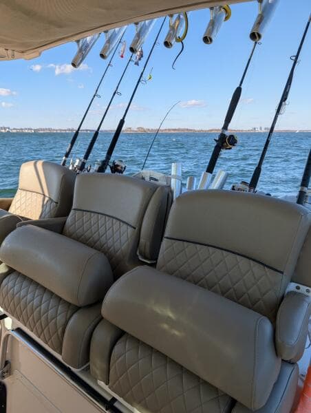 Luxury seating on 2012 Grady-White Canyon 366 boat with fishing rods in background.