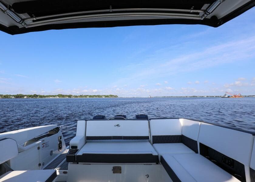 2023 Monterey 385 Super Sport boat with spacious seating, overlooking a serene water view.
