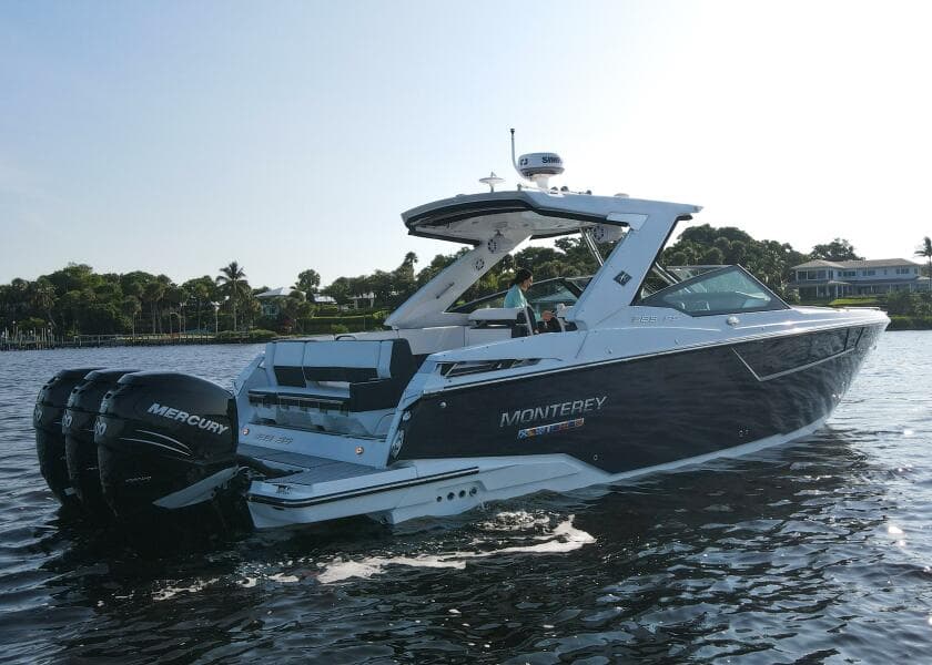 2023 Monterey 385 Super Sport boat cruising on a calm waterway.