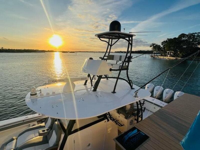 2024 Regulator 41 boat at sunset on calm waters, featuring advanced navigation equipment.