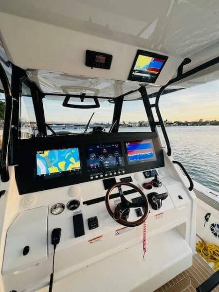 2024 Regulator 41 boat cockpit with advanced navigation displays at sunset.