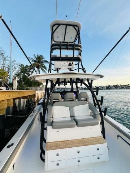 2024 Regulator 41 boat with tower, docked by the water, featuring seating and storage.