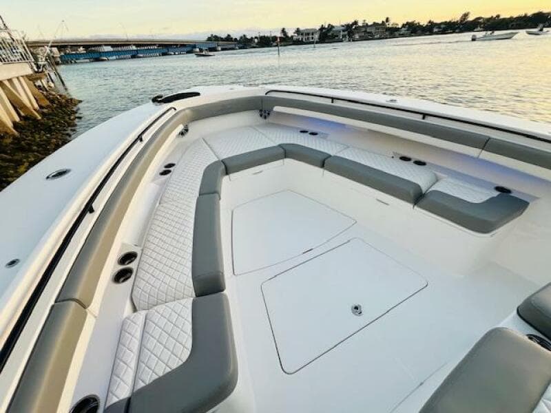 2024 Regulator 41 boat with spacious seating, docked by the water at sunset.