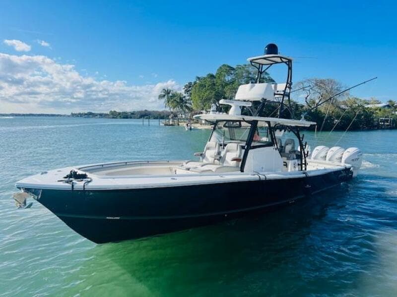 2024 Regulator 41 boat on clear water, featuring sleek design and multiple outboard engines.