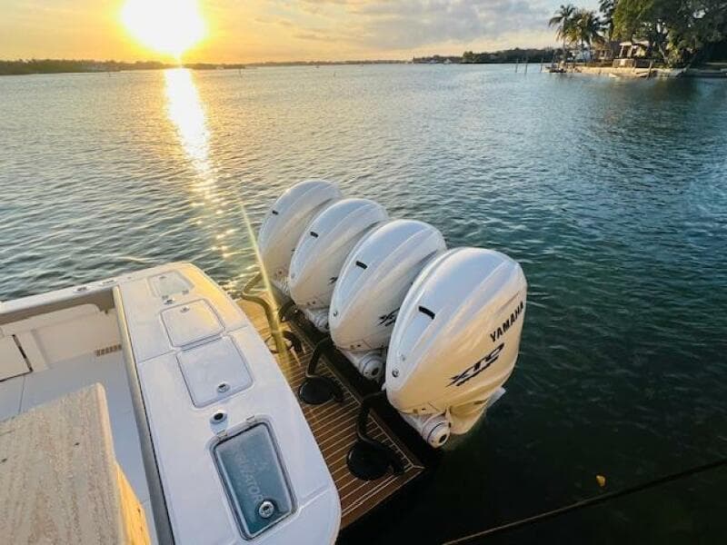 2024 Regulator 41 boat with Yamaha engines at sunset on a serene waterway.