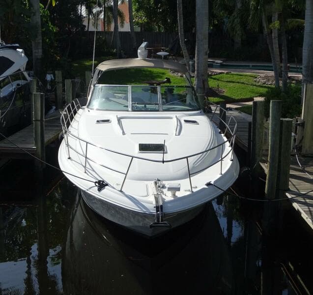 2001 Sea Ray 410 Sundancer docked in a serene marina setting.