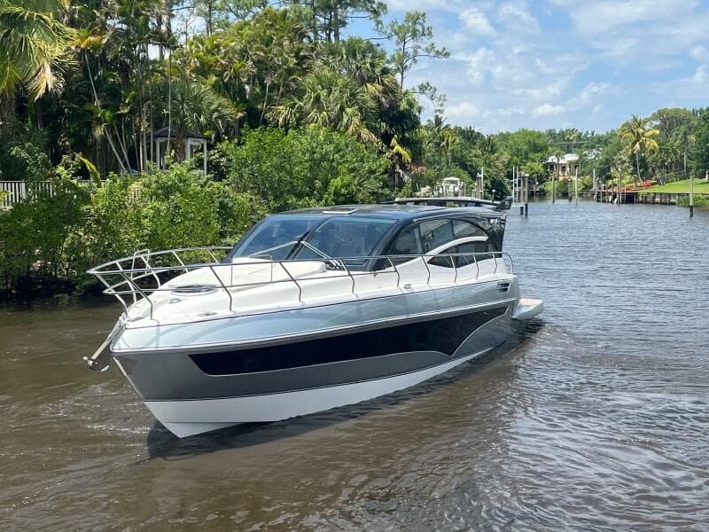 2025 Real 40 HT Luxury yacht cruising on a scenic river.