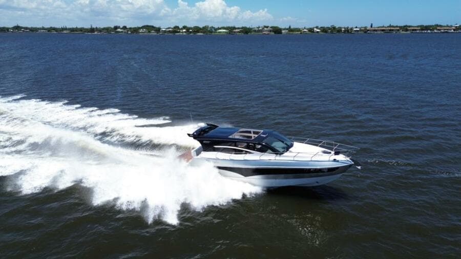 2025 Real 40 HT Luxury yacht cruising on open water, creating a dynamic wake.