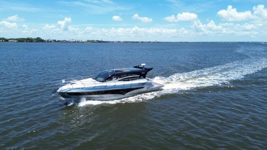 Luxury yacht Real 40 HT cruising on open water under a clear blue sky.