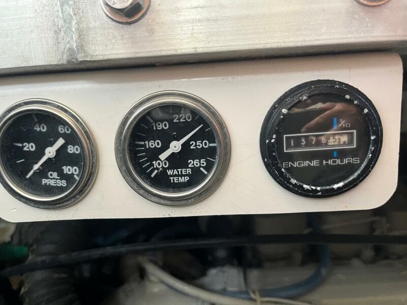 Gauges on a 2000 Carver 396 Motor Yacht showing oil pressure, water temperature, and engine hours.