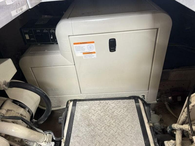 Engine room of 2000 Carver 396 Motor Yacht with generator and mechanical components.