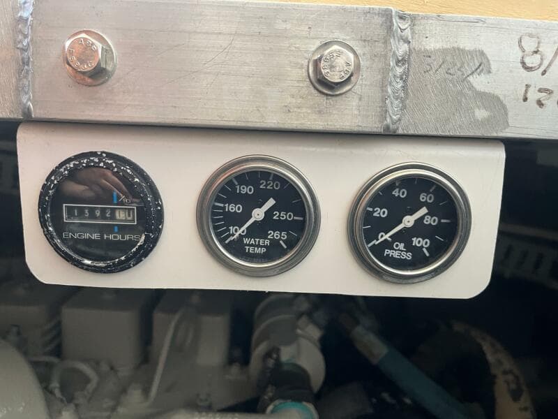 Gauges on a 2000 Carver 396 Motor Yacht displaying engine hours, water temperature, and oil pressure.