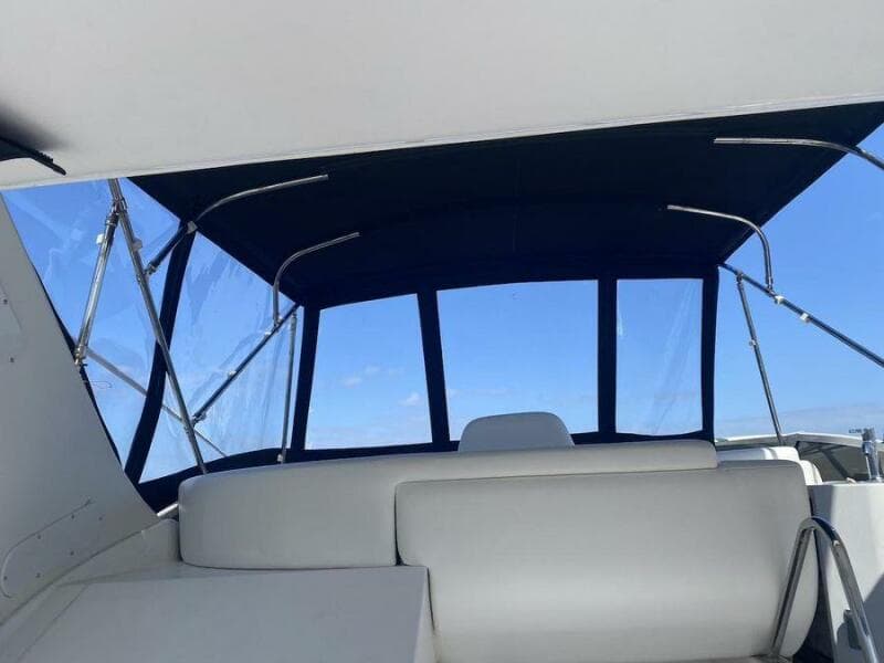 Interior view of 2000 Carver 396 Motor Yacht with white seating and blue canopy.