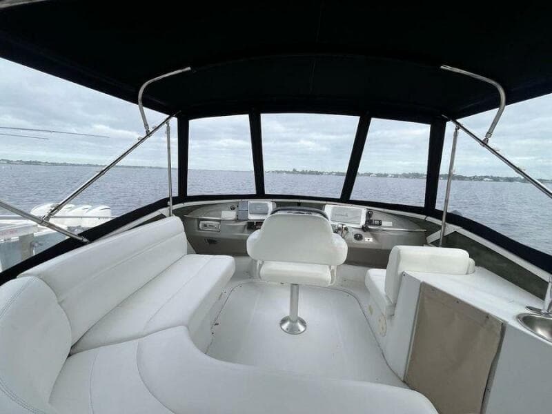 2000 Carver 396 Motor Yacht interior with white seating and panoramic windows.