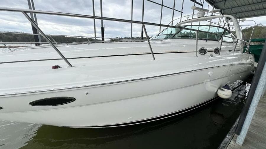 2001 Sea Ray 380 Sundancer yacht docked in a marina, side view.