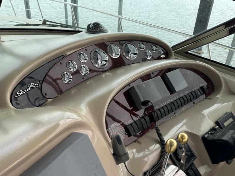 Control panel of a 2001 Sea Ray 380 Sundancer boat, featuring gauges and controls.