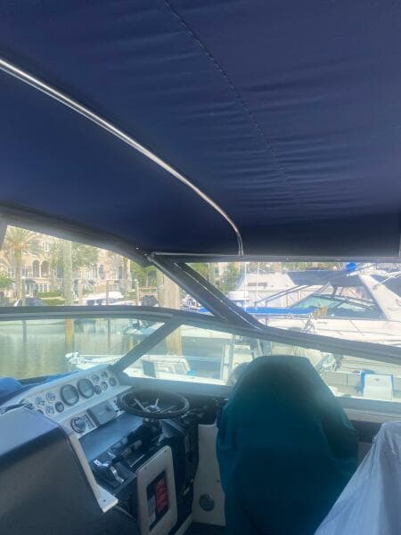 Interior view of 1993 Sea Ray 440 Sundancer boat cockpit with blue canopy.