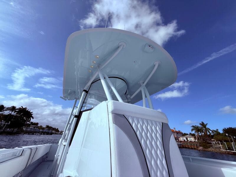 2024 Contender 39 ST boat with sleek design under a clear blue sky.