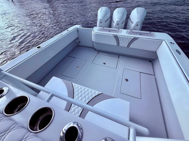 2024 Contender 39 ST boat with triple engines, spacious deck, and sleek design on the water.