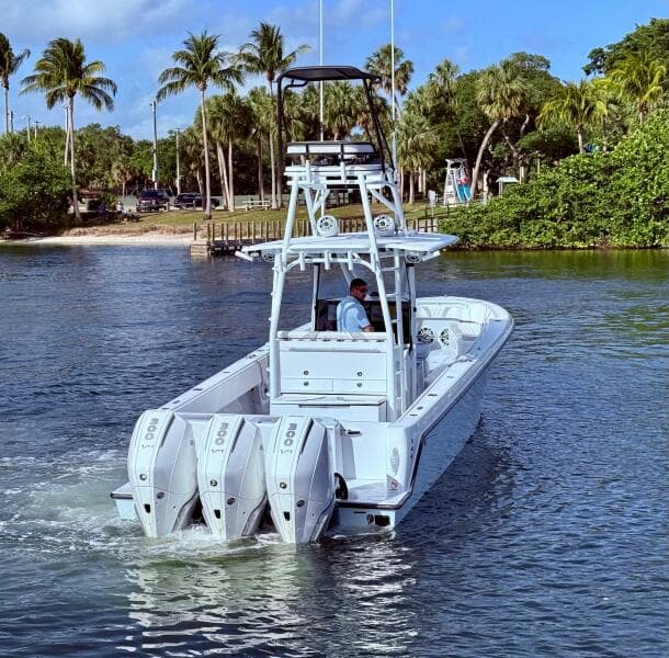 2024 Contender 39 ST boat with triple engines cruising in tropical waters.