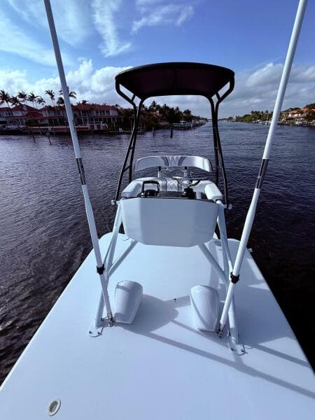 2024 Contender 39 ST boat on calm water with scenic background.