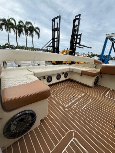Luxurious 2013 Statement 35 Center Console boat interior with plush seating and wood-patterned flooring.