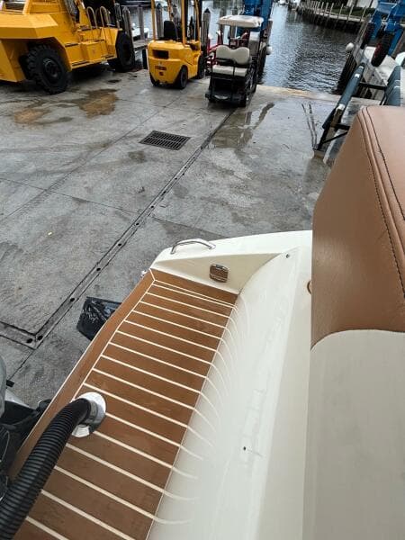 2013 Statement 35 Center Console boat at dock with forklifts and water view.