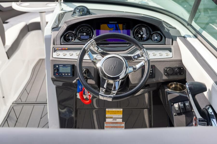 2023 Monterey 255 Super Sport boat dashboard with steering wheel and navigation controls.