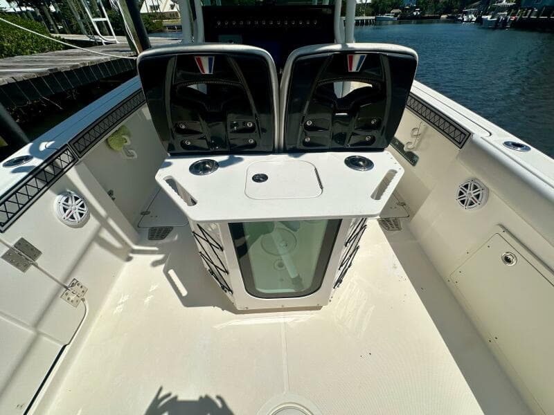 2019 Wellcraft 262 Fisherman boat interior with dual seats and storage, docked by the water.