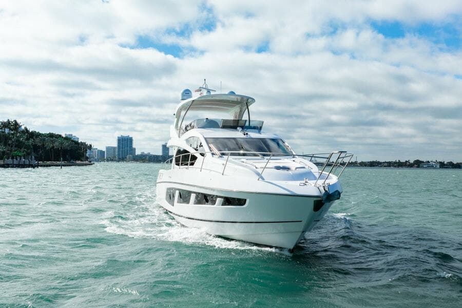 2016 Sunseeker Manhattan 65 yacht cruising on open water under a cloudy sky.