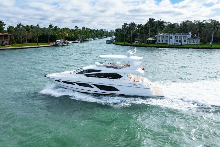 Sunseeker Manhattan 65 yacht cruising on a scenic waterway, 2016 model.