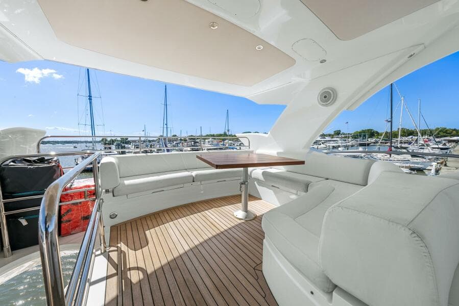 Luxurious 2016 Sunseeker Manhattan 65 yacht with spacious deck and marina view.