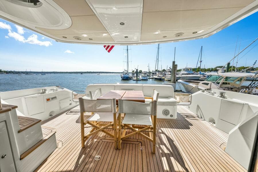 Luxury Sunseeker Manhattan 65 yacht deck with seating, overlooking marina, 2016 model.