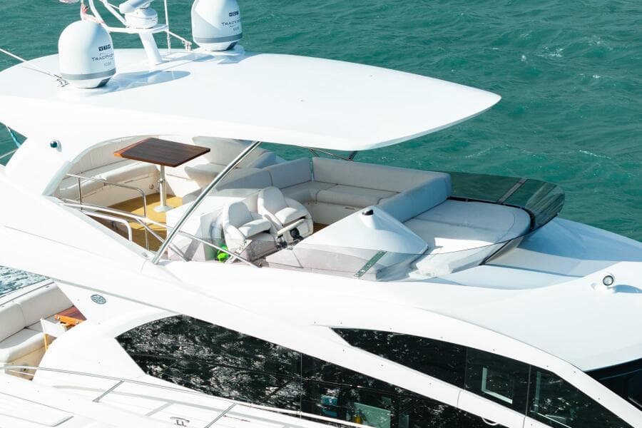 2016 Sunseeker Manhattan 65 yacht with spacious deck and seating, cruising on blue water.