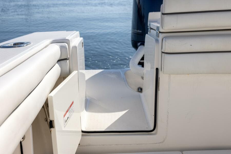 2018 Jupiter 26 FS boat interior with open hatch, white seating, and water view.