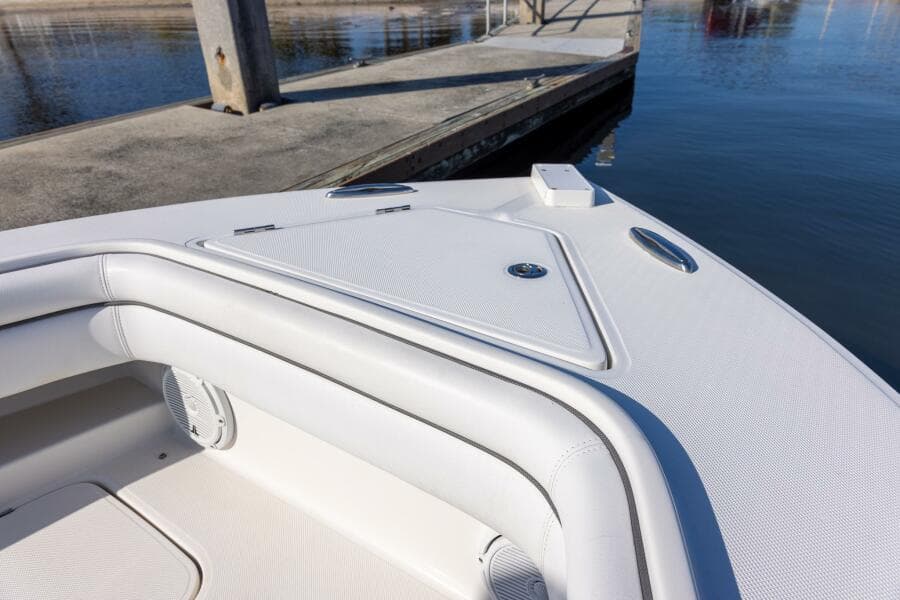 Bow of 2018 Jupiter 26 FS boat docked by calm water.