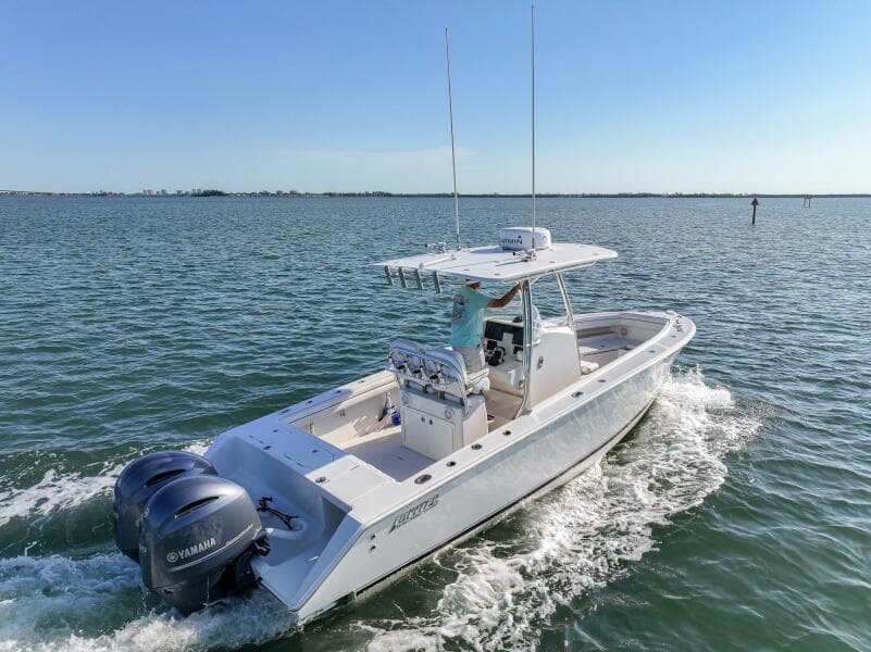2018 Jupiter 26 FS boat cruising on open water with dual Yamaha engines.