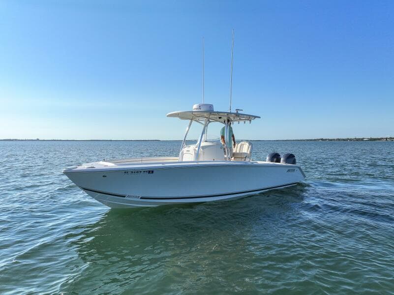 2018 Jupiter 26 FS boat cruising on calm waters under clear blue sky.